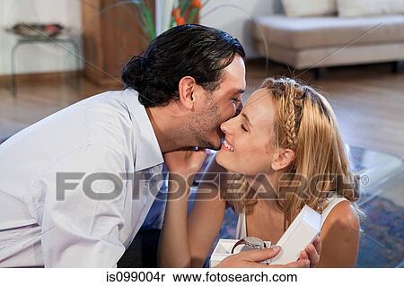 Woman giving gift of wrist watch to boyfriend View Large Photo Image Stock Photography - Woman giving gift of wrist watch to boyfriend. Fotosearch
