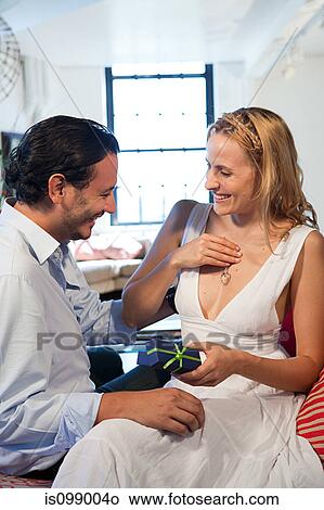 Woman with pendant gift received from boyfriend View Large Photo Image Picture - Woman with pendant gift received from boyfriend. Fotosearch