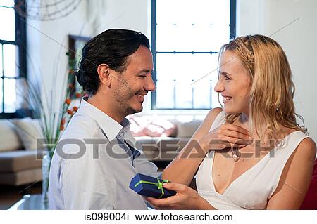 Stock Image - Woman with pendant gift received from boyfriend. Fotosearch