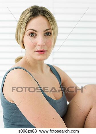 Stock Image - Portrait of young woman in bathroom. Fotosearch
