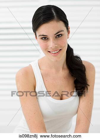 Stock Image - Portrait of young woman in bathroom. Fotosearch
