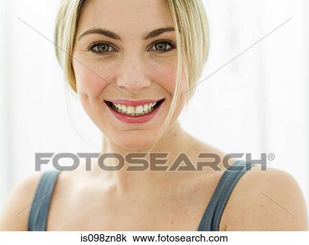Stock Image - Portrait of young woman in bathroom. Fotosearch