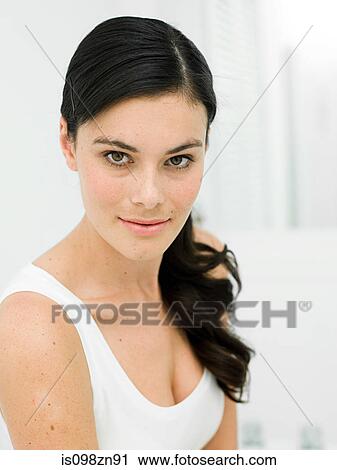 Stock Image - Portrait of young woman in bathroom. Fotosearch