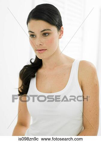Stock Image - Portrait of young woman in bathroom. Fotosearch