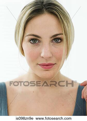 Stock Image - Portrait of young woman in bathroom. Fotosearch