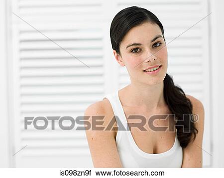 Stock Image - Portrait of young woman in bathroom. Fotosearch