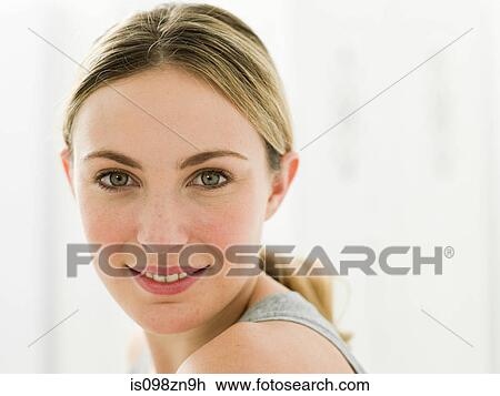 Stock Image - Portrait of young woman in bathroom. Fotosearch