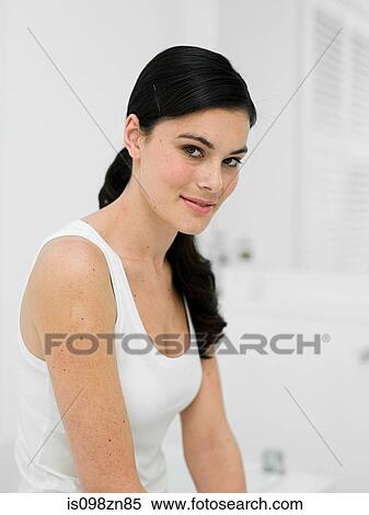 Stock Photography - Portrait of young woman in bathroom. Fotosearch