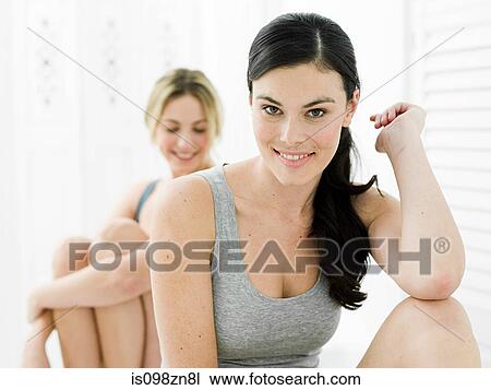 Stock Image - Portrait of young women in bathroom. Fotosearch