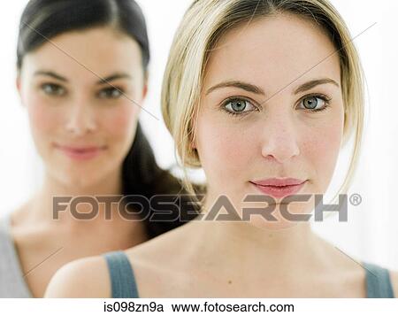 Stock Image - Portrait of young women in bathroom. Fotosearch