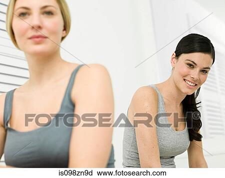 Stock Image - Portrait of young women in bathroom. Fotosearch