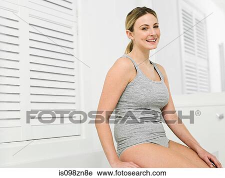 Young woman in bathroom with louvered door View Large Photo Image Stock Image - Young woman in bathroom with louvered door. Fotosearch