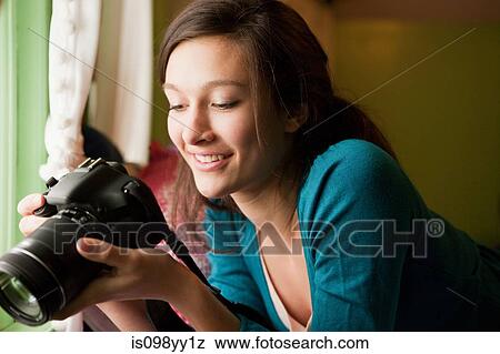 Teenage girl holding camera View Large Photo Image Stock Photo - Teenage girl holding camera. Fotosearch