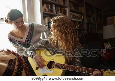 Teenage girls, one playing guitar View Large Photo Image Stock Image - Teenage girls, one playing guitar. Fotosearch