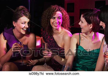 Four young women enjoying champagne in nightclub View Large Photo Image Stock Image - Four young women enjoying champagne in nightclub. Fotosearch