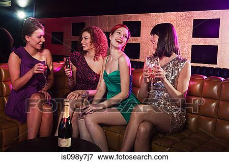 Four young women enjoying champagne in nightclub View Large Photo Image Stock Photo - Four young women enjoying champagne in nightclub. Fotosearch