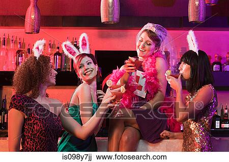 Stock Image - Four young women on hen night. Fotosearch