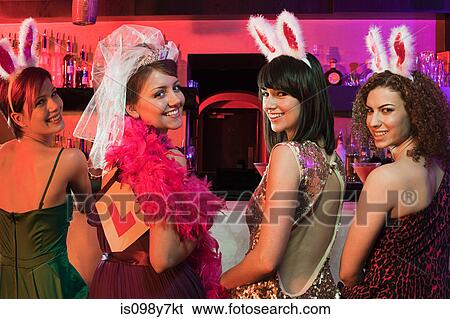 Stock Photograph - Four young women on hen night. Fotosearch