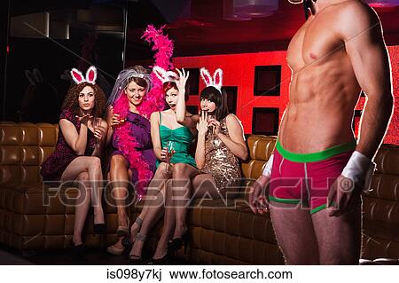 Stock Image - Young women on hen night with male stripper. Fotosearch