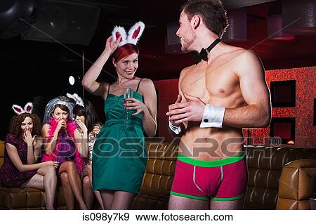 Stock Photo - Young women on hen night with male stripper. Fotosearch