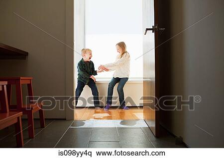 Brother and sister sitting on windowsill View Large Photo Image Stock Photography - Brother and sister sitting on windowsill. Fotosearch
