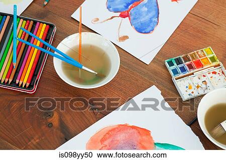 Children's paintbrushes and paintings on table View Large Photo Image Stock Image - Children's paintbrushes and paintings on table. Fotosearch