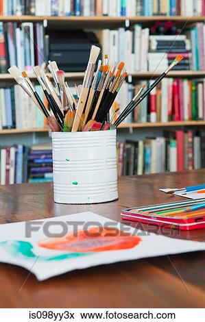Children's paintbrushes and paintings on table View Large Photo Image Stock Photo - Children's paintbrushes and paintings on table. Fotosearch