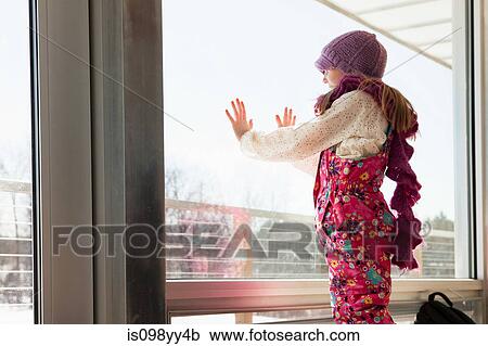 Girl looking through window View Large Photo Image Stock Image - Girl looking through window. Fotosearch