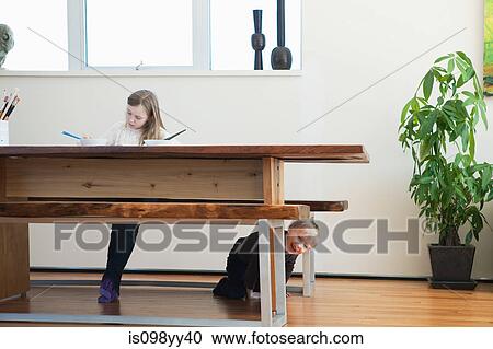 Girl painting, brother under table View Large Photo Image Stock Image - Girl painting, brother under table. Fotosearch