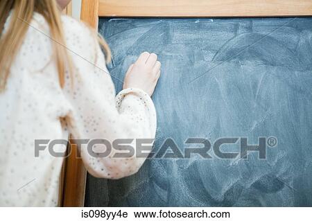 Stock Image - Girl writing on blank blackboard. Fotosearch