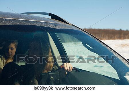 Stock Image - Mother and daughter driving in car. Fotosearch