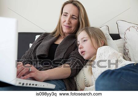 Mother and daughter using laptop View Large Photo Image Stock Photography - Mother and daughter using laptop. Fotosearch
