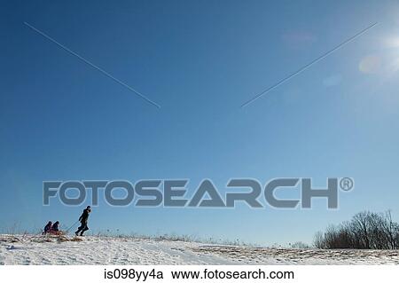 Mother and two children with toboggan View Large Photo Image Stock Image - Mother and two children with toboggan. Fotosearch