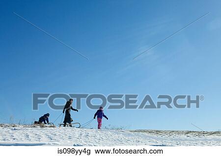 Mother and two children with toboggan View Large Photo Image Stock Image - Mother and two children with toboggan. Fotosearch