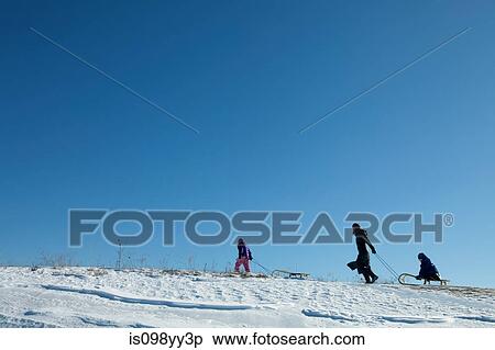 Mother and two children with toboggan View Large Photo Image Stock Photography - Mother and two children with toboggan. Fotosearch