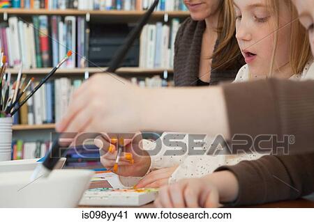 Stock Image - Sister and brother painting pictures. Fotosearch
