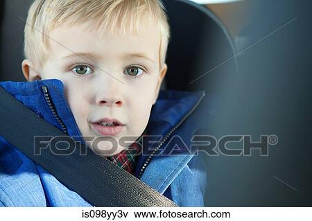Stock Photo - Young boy wearing car seatbelt. Fotosearch