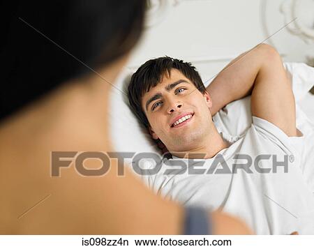 Picture - Young couple on bed together. Fotosearch