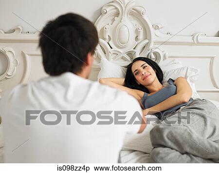 Young couple on bed together View Large Photo Image Stock Photography - Young couple on bed together. Fotosearch
