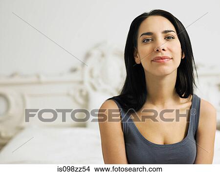 Picture - Young woman on bed, portrait. Fotosearch
