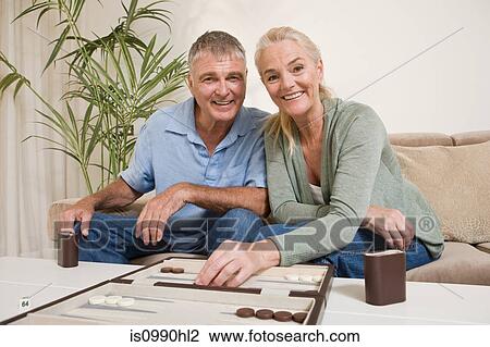 Couple playing backgammon View Large Photo Image Stock Image - Couple playing backgammon. Fotosearch