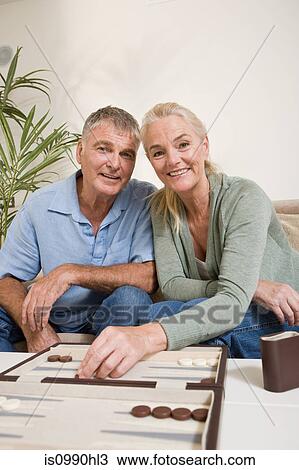 Stock Image - Couple playing backgammon. Fotosearch