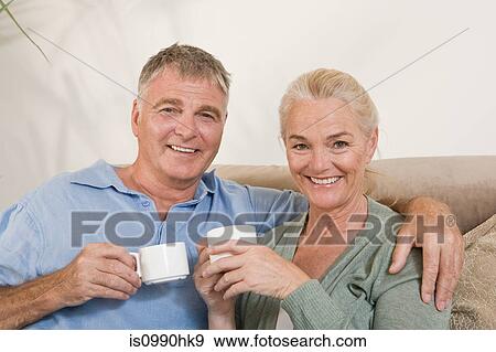 Couple with cups of coffee View Large Photo Image Stock Photo - Couple with cups of coffee. Fotosearch