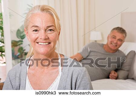 Stock Image - Mature couple in bedroom. Fotosearch