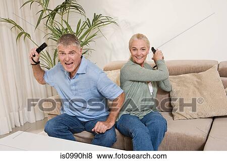 Mature couple playing video game View Large Photo Image Stock Photo - Mature couple playing video game. Fotosearch