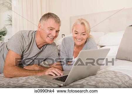 Mature couple using laptop View Large Photo Image Picture - Mature couple using laptop. Fotosearch