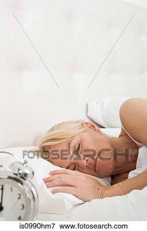 Mature woman asleep in bed View Large Photo Image Stock Photo - Mature woman asleep in bed. Fotosearch