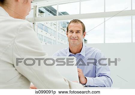 Businessman and businesswoman meeting in office View Large Photo Image Stock Photography - Businessman and businesswoman meeting in office. Fotosearch