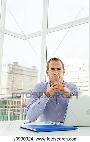 Picture - Businessman in office. Fotosearch