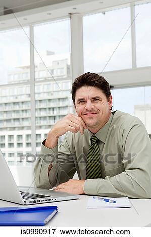 Businessman in office View Large Photo Image Stock Photo - Businessman in office. Fotosearch